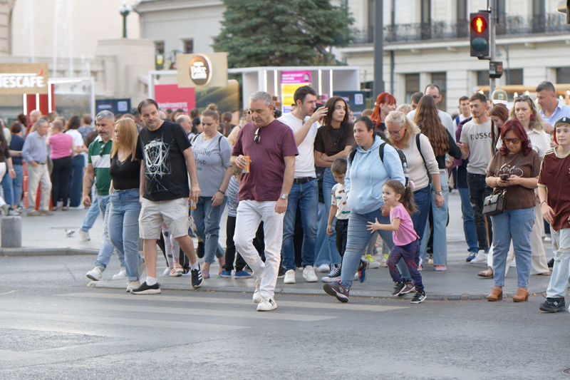 19 - Pedestrians crossing the street at a crosswalk during an urban event, such as a pedestrian weekend on Calea Victoriei in Bucharest